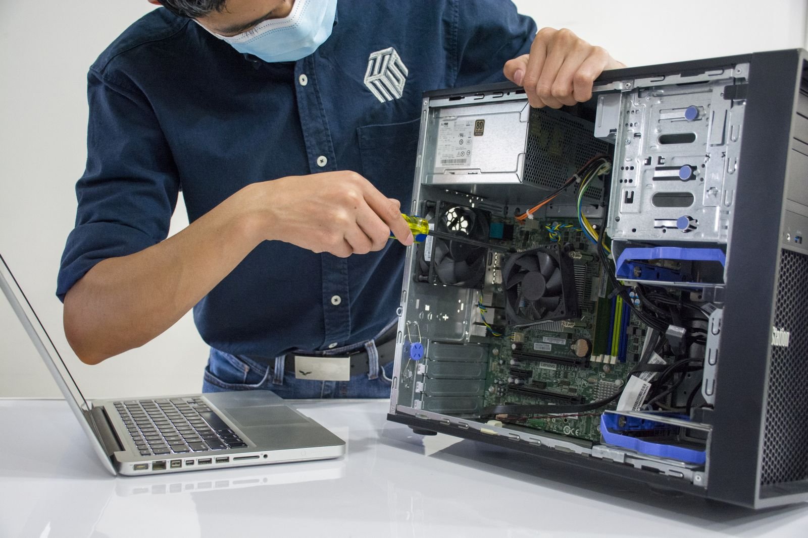 Technician working inside a desktop computer